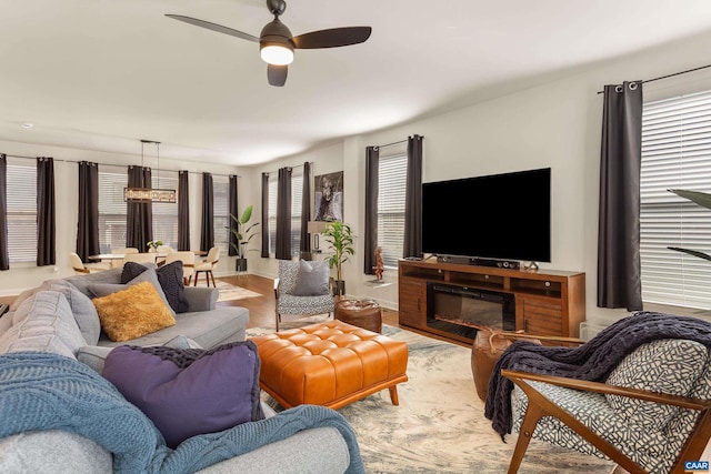 living room with ceiling fan and light wood-type flooring