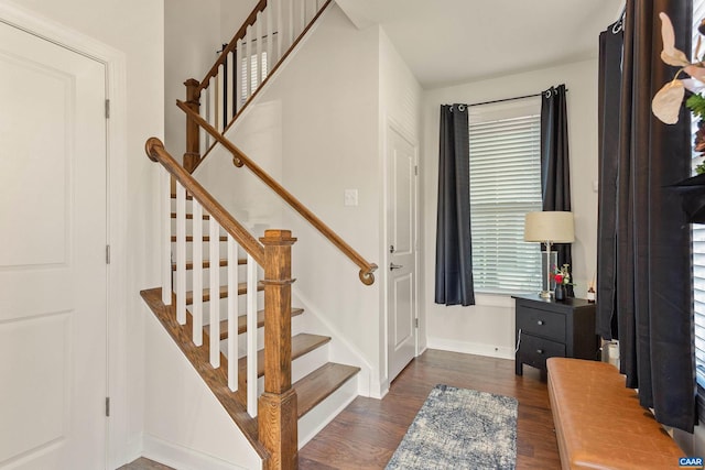 stairs featuring hardwood / wood-style floors