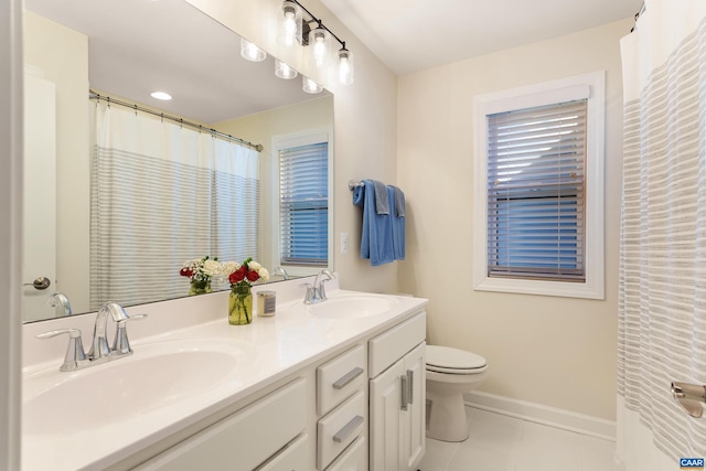 bathroom featuring tile patterned flooring, vanity, and toilet