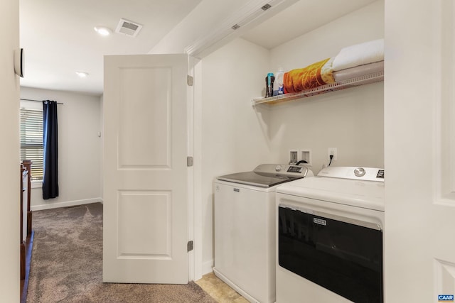 laundry room with independent washer and dryer and carpet flooring