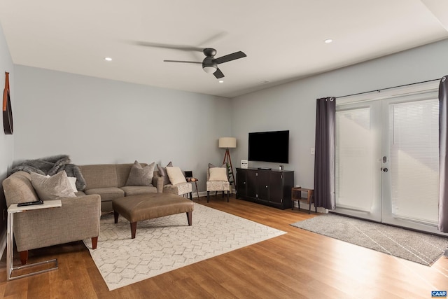 living room with ceiling fan and hardwood / wood-style floors