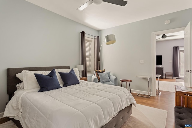 bedroom featuring ceiling fan and light hardwood / wood-style flooring