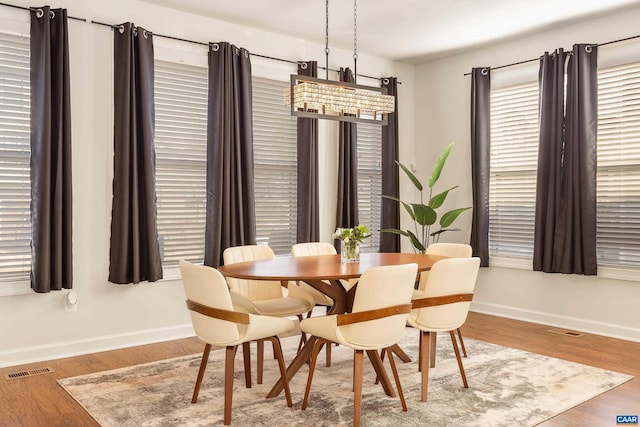 dining space with wood-type flooring