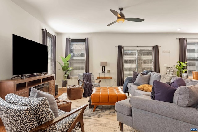 living room with ceiling fan and light hardwood / wood-style floors