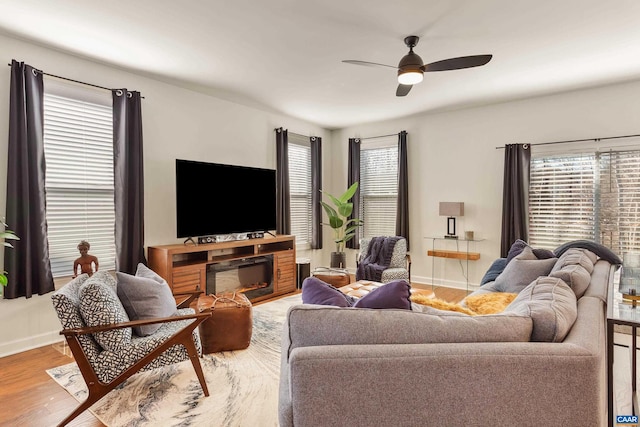 living room featuring hardwood / wood-style flooring, plenty of natural light, and ceiling fan