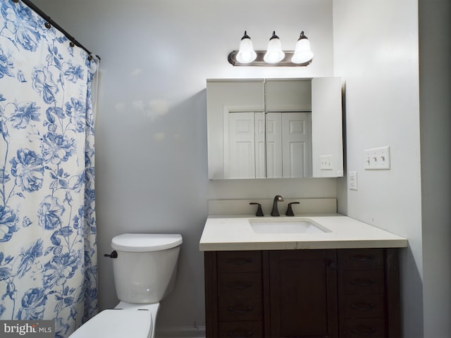 bathroom featuring vanity, toilet, and curtained shower