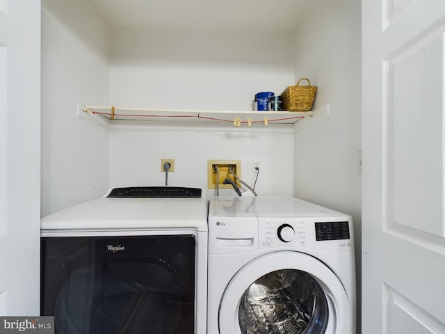 laundry room featuring washing machine and clothes dryer