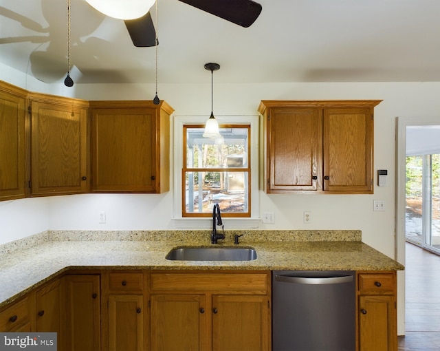 kitchen featuring sink, light stone counters, hanging light fixtures, dishwasher, and ceiling fan