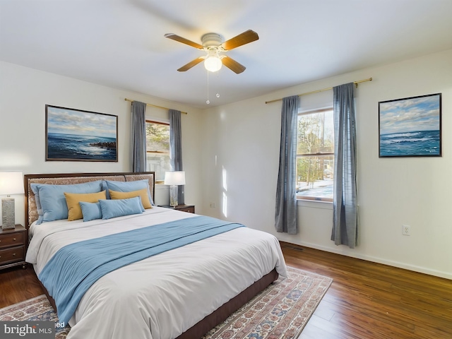 bedroom with dark wood-type flooring and ceiling fan