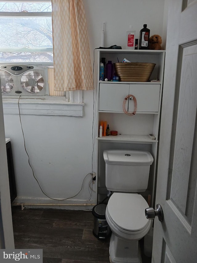 bathroom featuring wood-type flooring and toilet