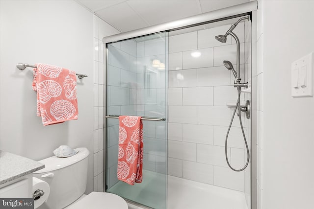 bathroom with walk in shower, vanity, and toilet