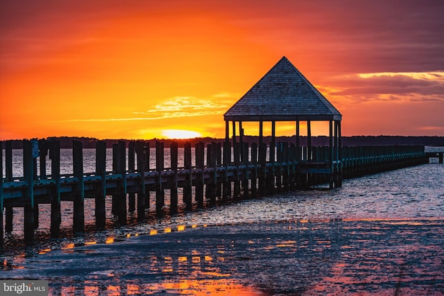 view of dock featuring a gazebo and a water view