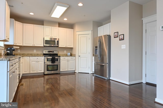 kitchen featuring white cabinets and appliances with stainless steel finishes