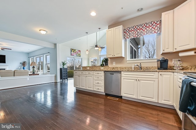 kitchen with pendant lighting, white cabinets, stainless steel dishwasher, ceiling fan, and light stone counters