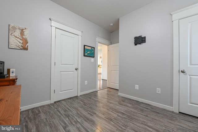 unfurnished bedroom featuring dark hardwood / wood-style floors