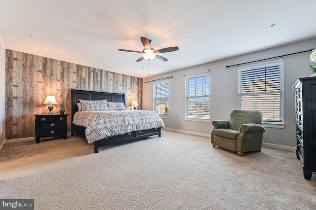 bedroom featuring carpet floors, ceiling fan, and wood walls