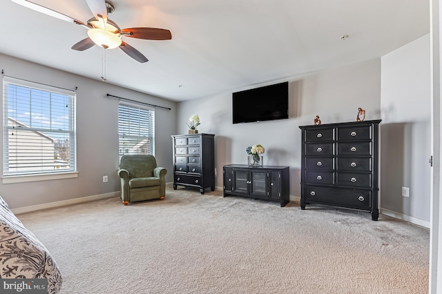 living area featuring light colored carpet and ceiling fan