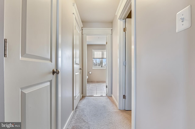 hallway featuring light carpet