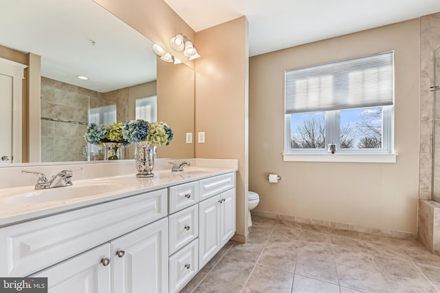 bathroom with vanity, a shower with shower door, tile patterned floors, and toilet