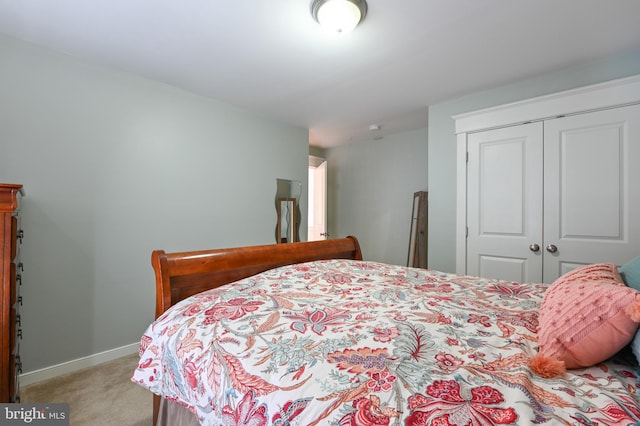 bedroom with light colored carpet and a closet