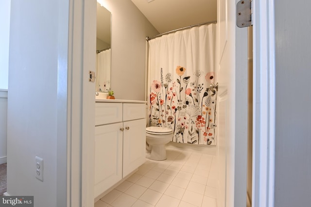 bathroom featuring vanity, tile patterned floors, and toilet