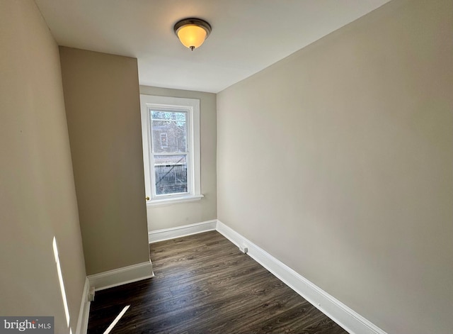 unfurnished room with dark hardwood / wood-style floors