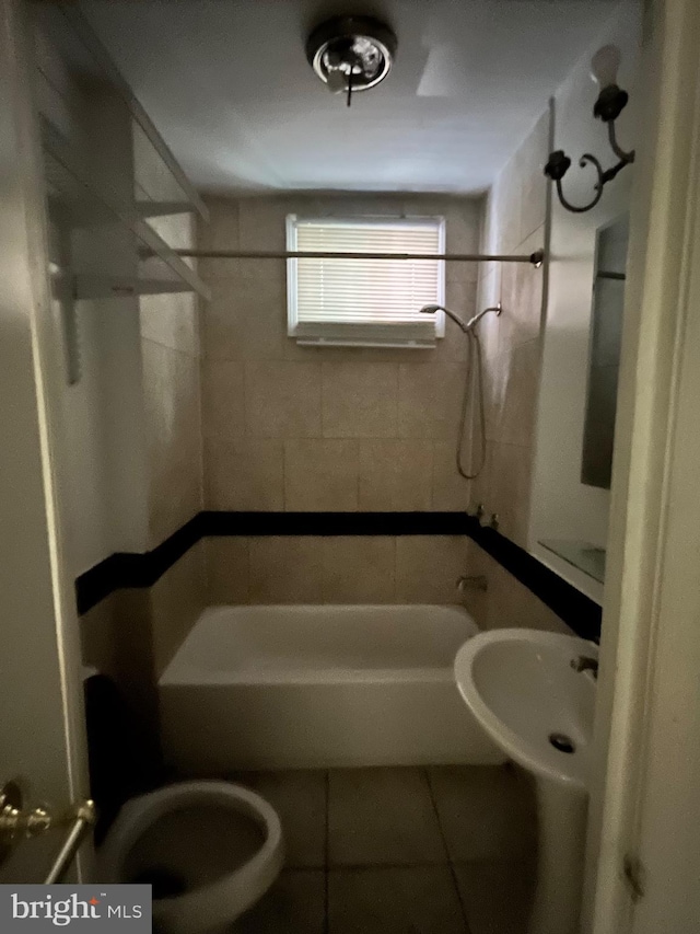 full bathroom with toilet, sink, tile patterned floors, and  shower combination