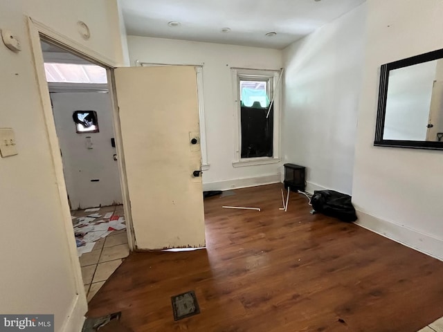 entryway with plenty of natural light and dark hardwood / wood-style flooring