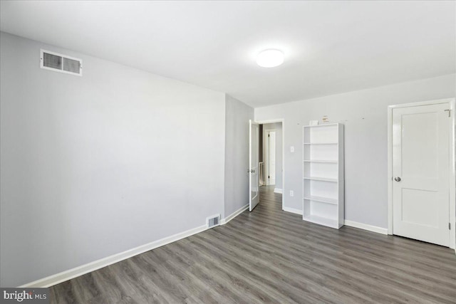 unfurnished bedroom featuring dark hardwood / wood-style floors