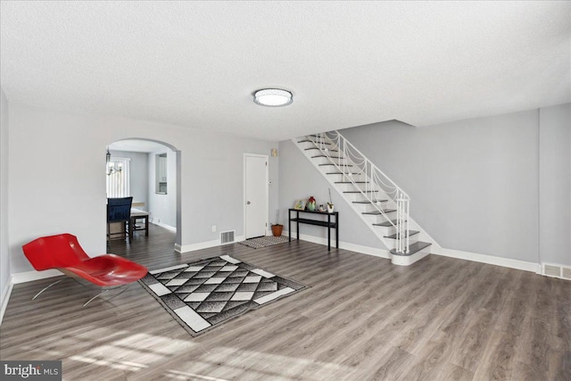 sitting room featuring wood-type flooring and a textured ceiling