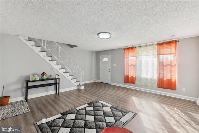 living room with hardwood / wood-style floors and a textured ceiling