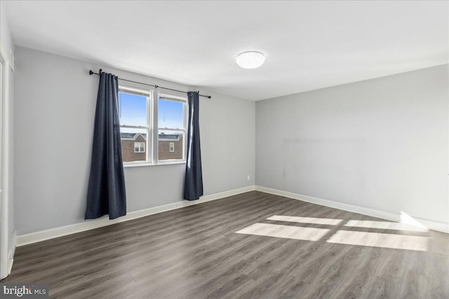 spare room with dark hardwood / wood-style floors