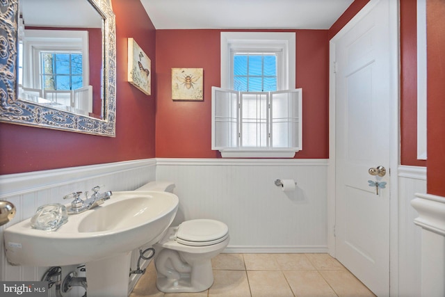 bathroom with toilet and tile patterned flooring