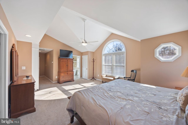 bedroom with lofted ceiling, connected bathroom, light colored carpet, and ceiling fan