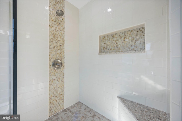 bathroom with tiled shower