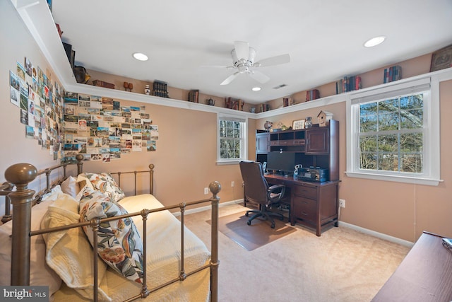 carpeted home office featuring ceiling fan