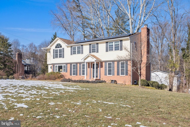 colonial inspired home with a front yard