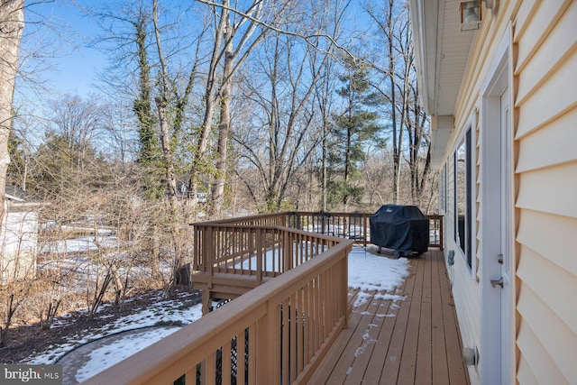 snow covered deck featuring a grill