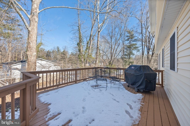 snow covered deck with a grill