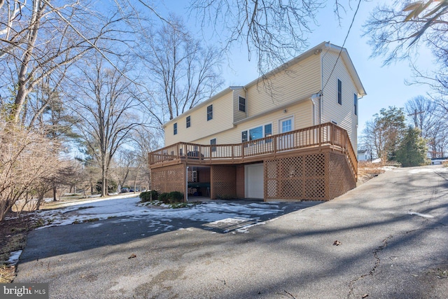 back of house with a wooden deck