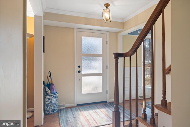 entrance foyer featuring crown molding and wood-type flooring