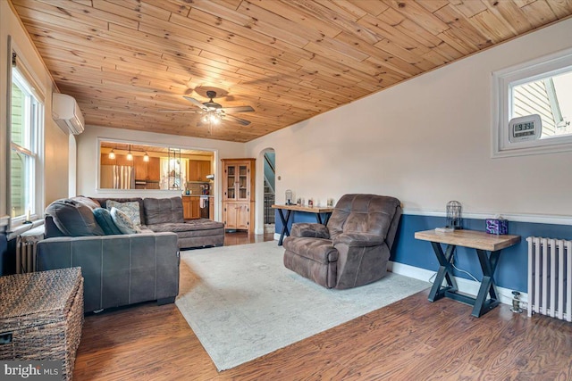 living room with dark wood-type flooring, a wall mounted AC, radiator, and wooden ceiling