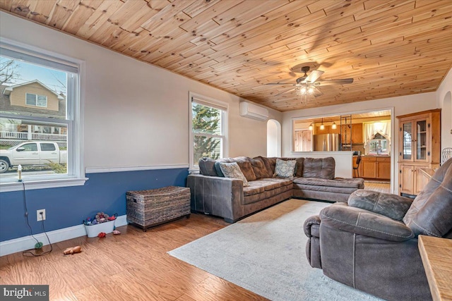 living room with wood ceiling, ceiling fan, a wall mounted air conditioner, and light hardwood / wood-style flooring