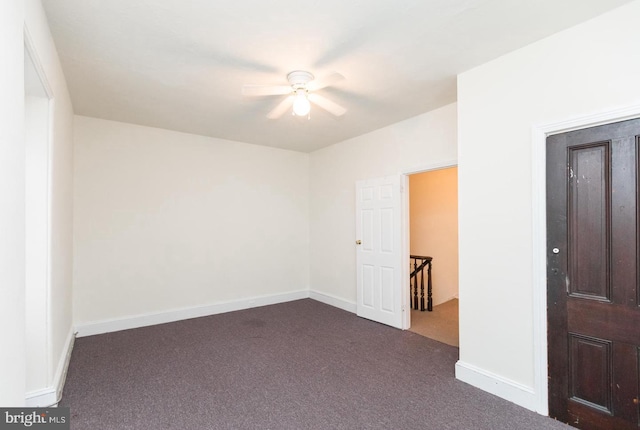 carpeted empty room featuring ceiling fan