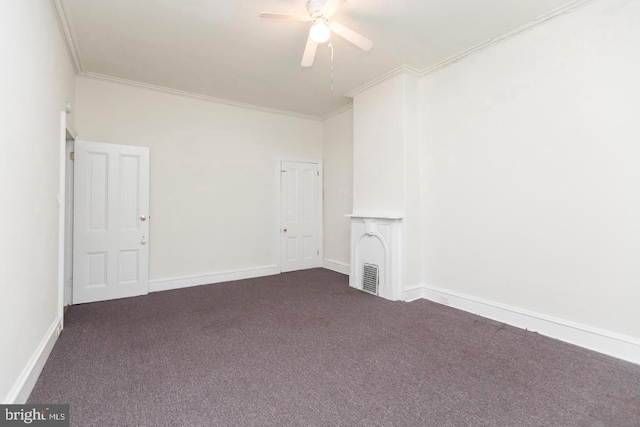 unfurnished room featuring dark colored carpet, ornamental molding, and ceiling fan