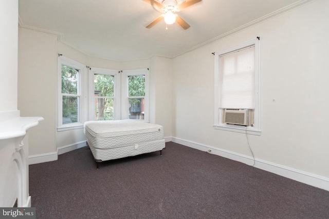 unfurnished bedroom featuring ornamental molding, dark carpet, cooling unit, and ceiling fan