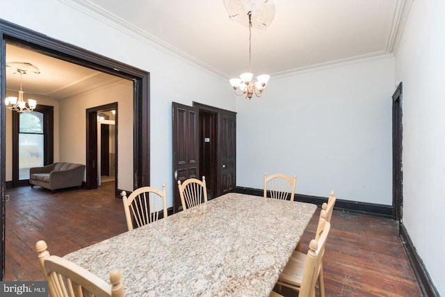 dining room with crown molding, dark hardwood / wood-style floors, and a chandelier