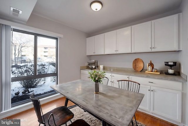 dining space with light hardwood / wood-style floors