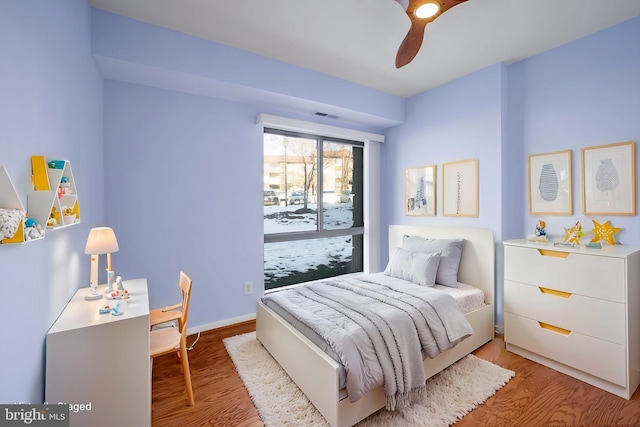 bedroom with light hardwood / wood-style flooring and ceiling fan