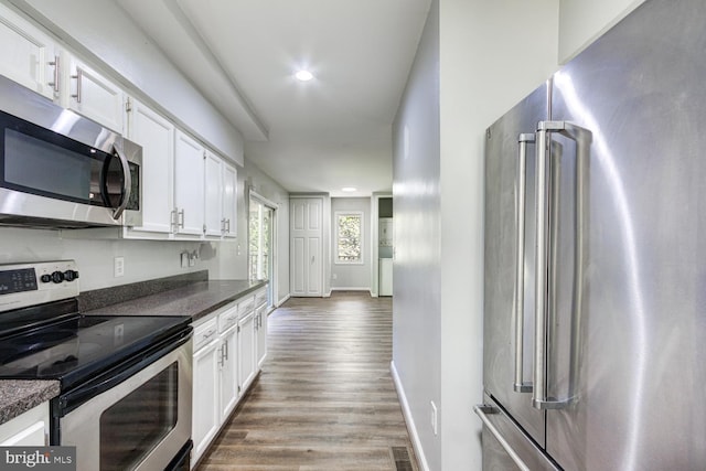 kitchen featuring white cabinetry, appliances with stainless steel finishes, and hardwood / wood-style flooring